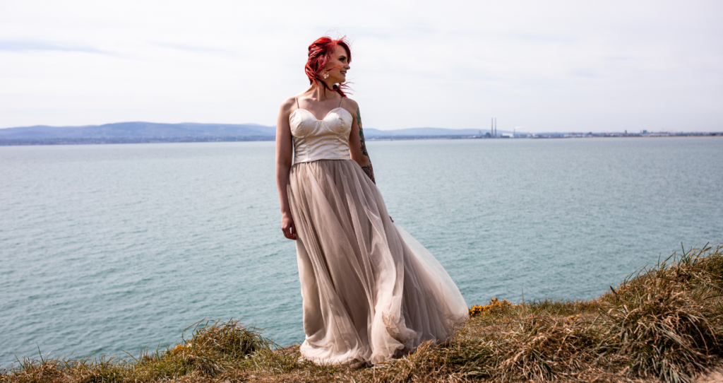 modern bride standing at Howth cliffs